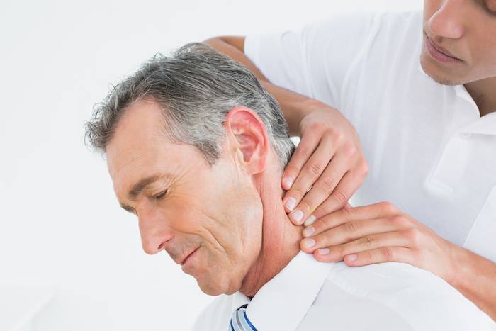 An image contain a person taking physical therapy to treat his neck pain